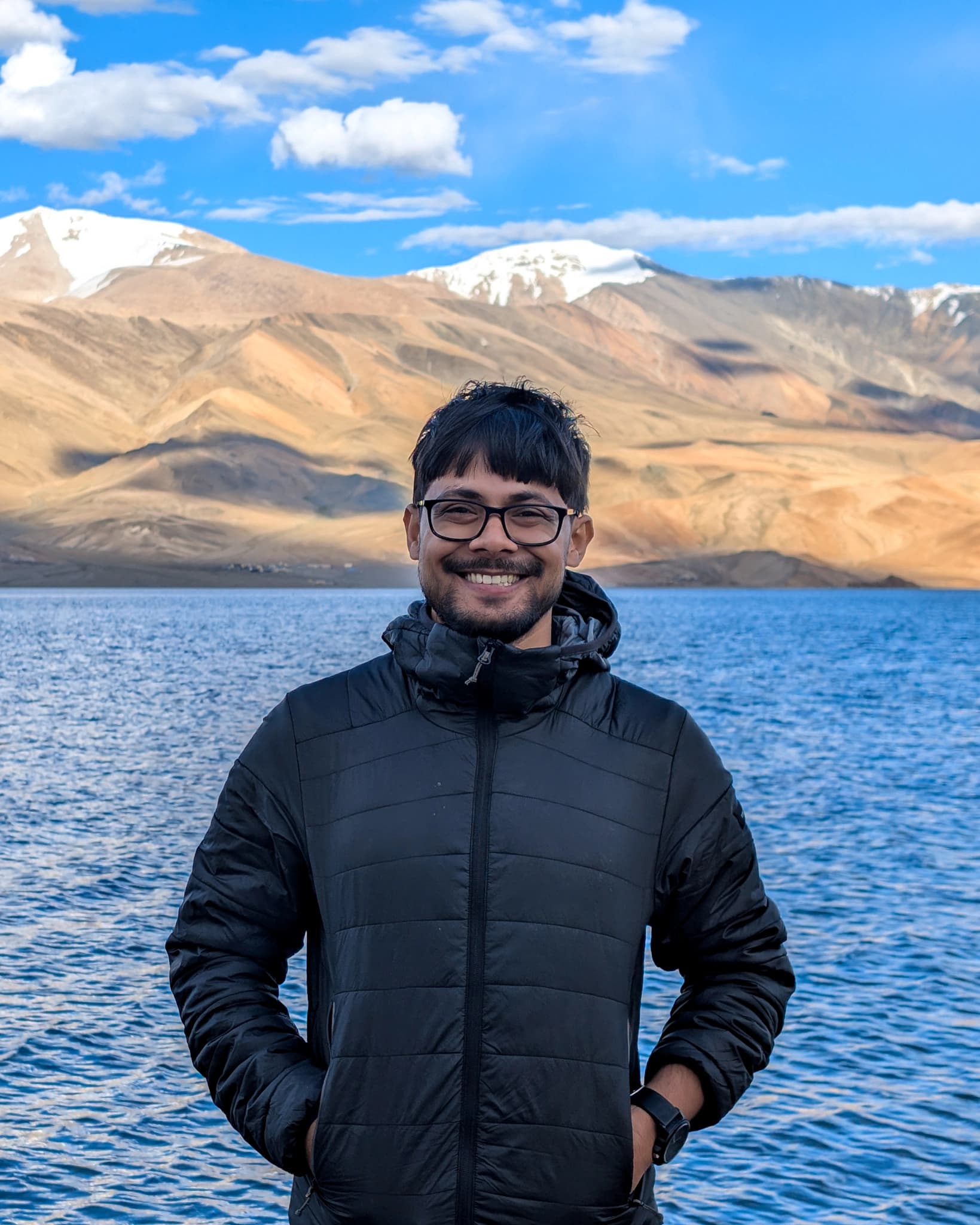 Shovan standing in front of blue lake